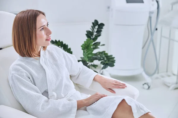 Happy smiling adult female in white bathrobe relaxing in spa resort hotel — Stock Photo, Image