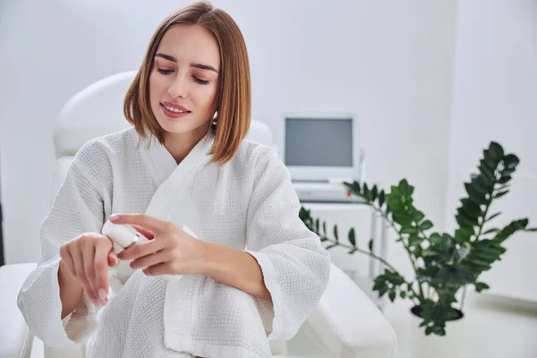 Young beautiful elegant female in white bathrobe spending time in spa relax complex — Stock Photo, Image