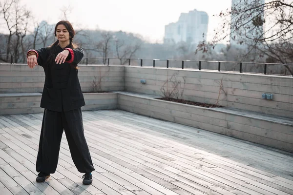 Женщина тайцзицюань эксперт висит руки в одиночку на крыше — стоковое фото