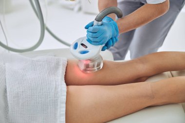 Professional beautician making Anti cellulite massage for buttocks and thighs wellness center