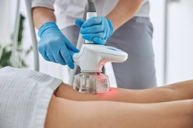 Image of beautician doing beauty ultrasonic massage therapy in wellness center