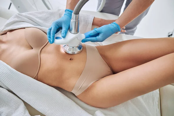 Elegant woman getting anti-fat treatment at beauty salon — Foto de Stock