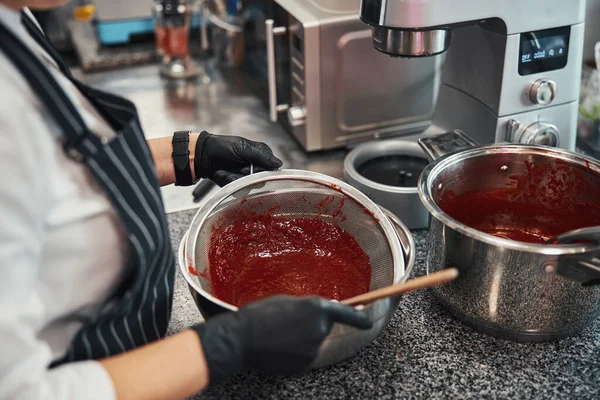 Enthusiastic chef working on batch of delicious jam — Photo