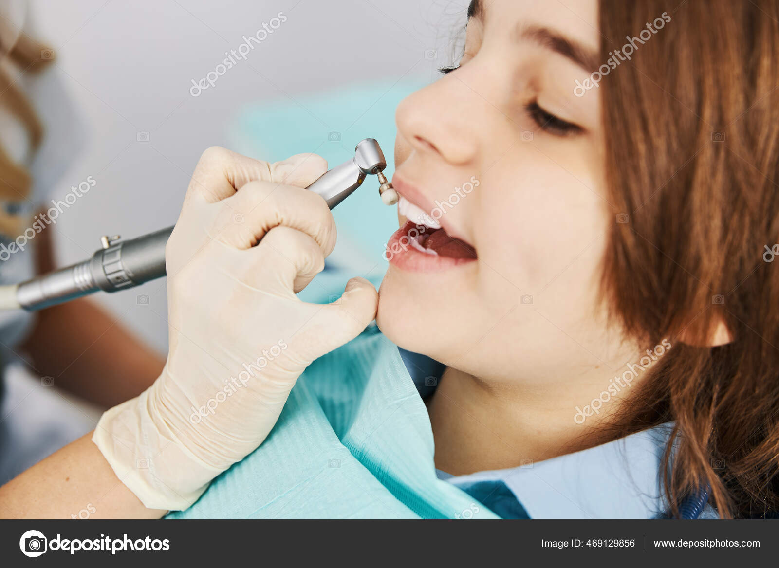 Dental drill with prophy brush treating boy teeth Stock Photo by