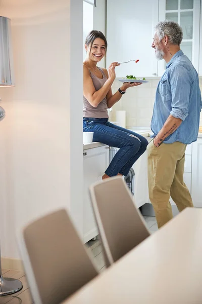Positive brunette female person feeding her man — Stock Photo, Image