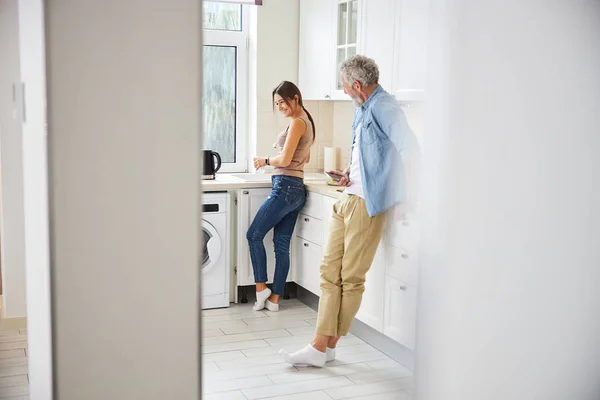 Sincere young woman standing in the kitchen — Stock Photo, Image