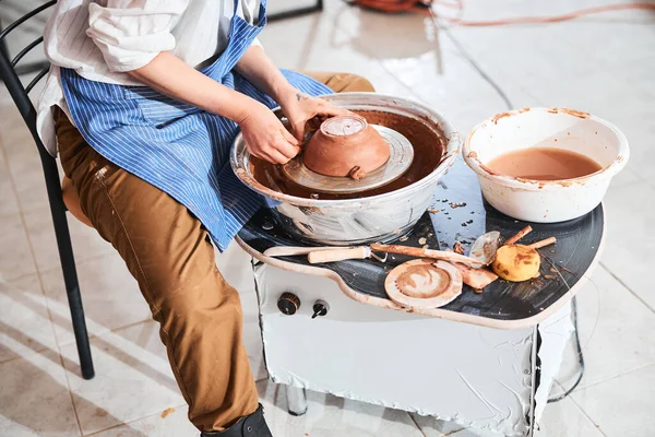 Pottery artist placing clay lump near bowl rim on wheel — Stock Photo, Image