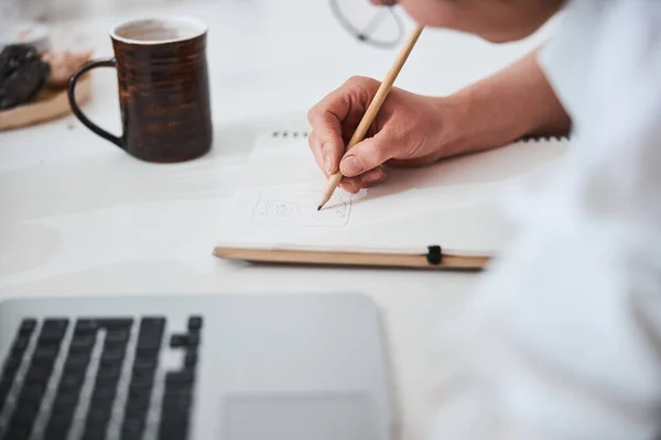 Pencil in person hand drawing animal on paper — Stock Photo, Image