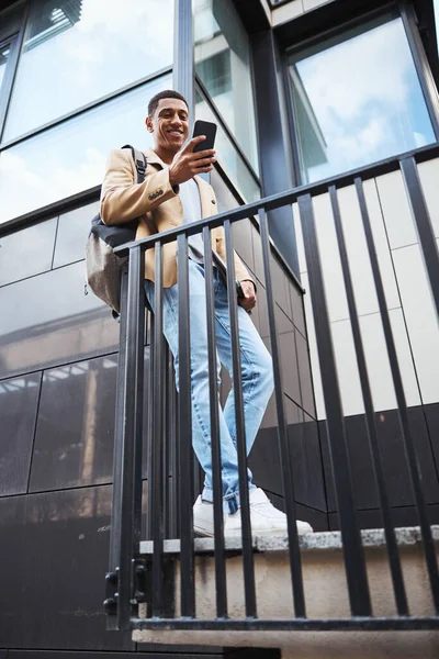 Pleased international male person spending break outdoors — Stock fotografie