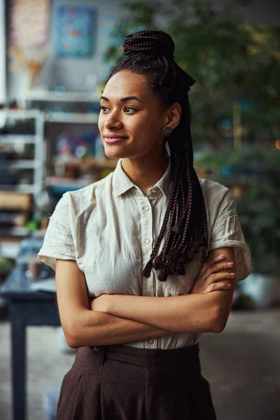 Dark-haired floral decorator daydreaming in her workplace — Stock Photo, Image