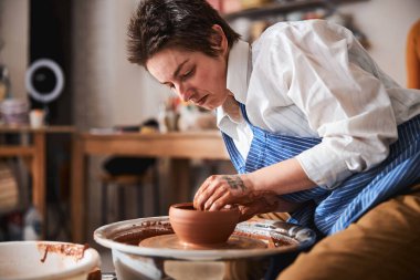 Portrait of kind potter doing ceramics for sale
