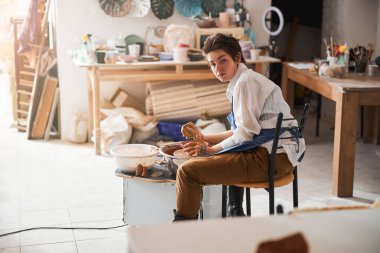 Attentive brunette female looking straight at camera