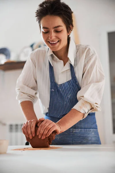 Cheerful female person spending her weekend in pottery — ストック写真