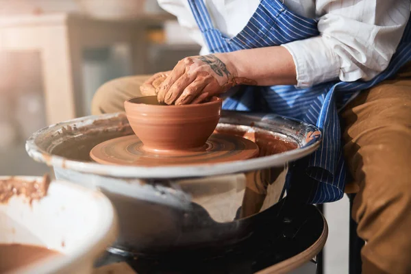 Close up of professional master molding new pot — Photo