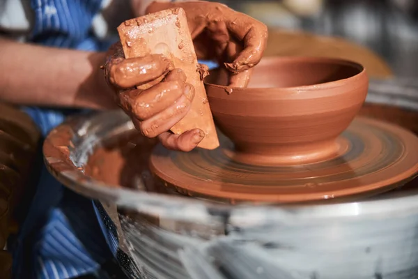 Competent craftsperson using tools for molding bowl — Photo