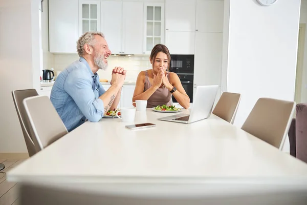 Two loving people watching film while having dinner — Stock Photo, Image