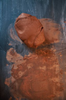 Image of brown lump of earthenware tool in pottery workshop clipart