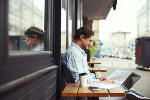 Cheerful male having online conversation per video