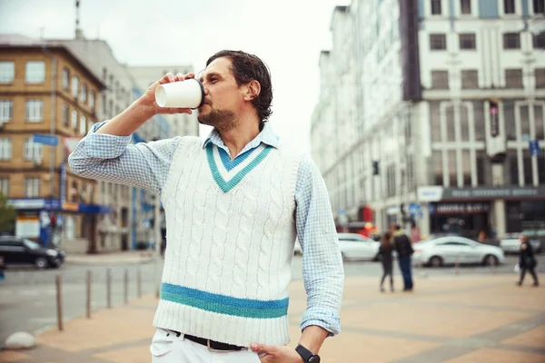 Kind bearded man tasting aroma coffee during walk — Stock Photo, Image