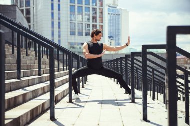 Kind serious man standing in pose of martial arts