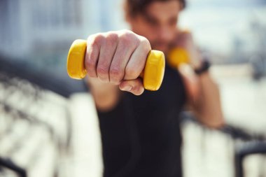 Close up of male hand holding dumbbell