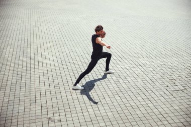 Handsome brunette man doing sport alone for pleasure