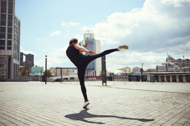 Active male person making a swing with foot
