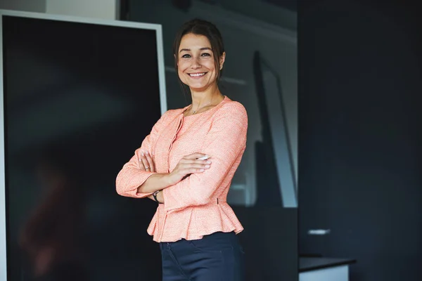 Young Caucasian female designer posing and looking at the photo camera in the modern luxury office — Stockfoto