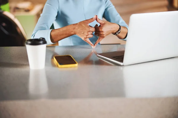 Charming online teacher using technology to communicate with international sign language in bright office — Stockfoto