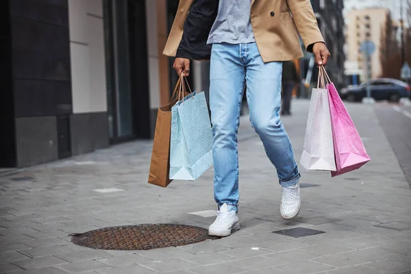 Kind male person having walk after shopping