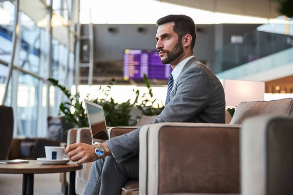 Thoughtful attractive businessman with cup of coffee — Stock Photo, Image