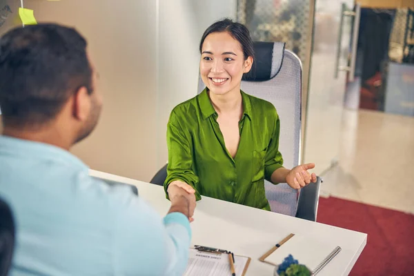 Positive delighted woman welcoming her new colleague — Stock Photo, Image