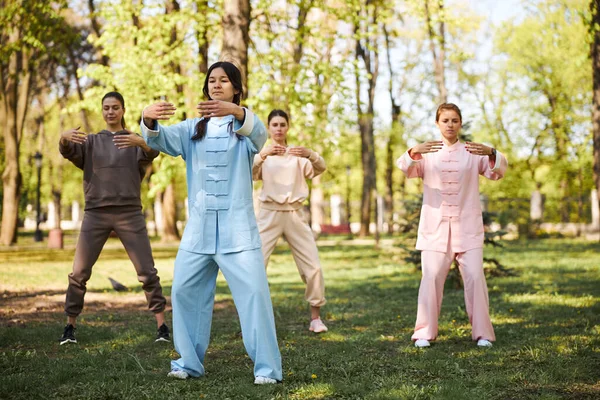 Females standing straight and stretching arms in front of themselves — Stock Photo, Image