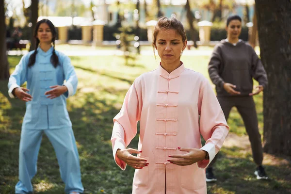 Female tai chi student holding arms at belly level — Stock Photo, Image