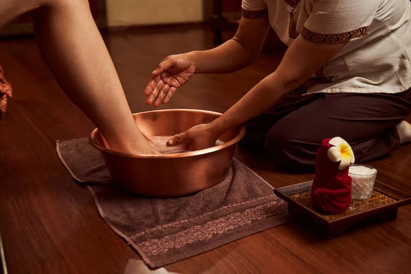 Professional podiatrist preparing client feet for pedicure — Stock Photo, Image