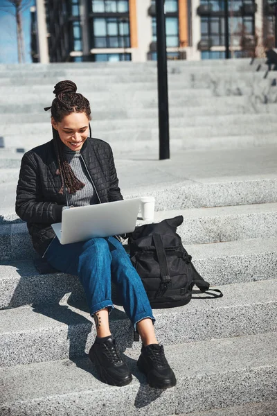 Radosna kobieta freelancer pracuje na swoim laptopie na zewnątrz — Zdjęcie stockowe