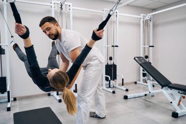 Therapeutic exercise kinesitherapy of young woman on decompression simulator in physiotherapy office