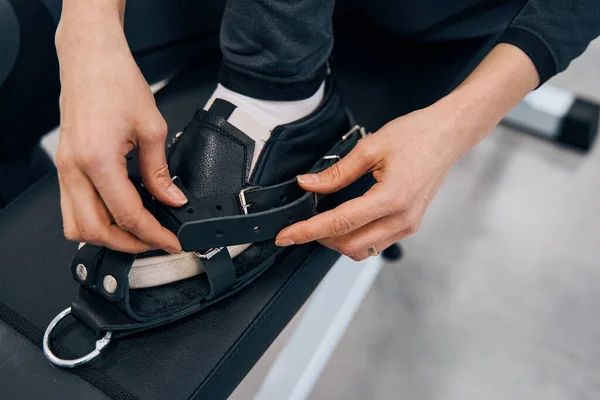 Close-up of young woman with special rehabilitation shoes on foot. Preparing to strength training — Stock Photo, Image