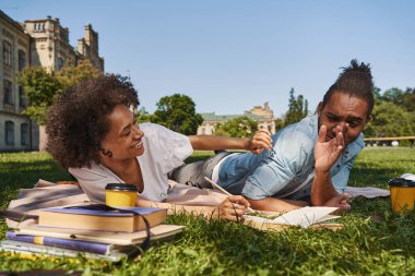 Young couple being in playful mood while relaxing outdoors