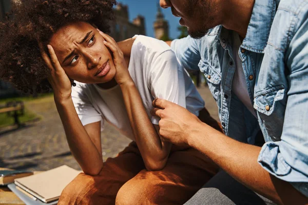 Upset young woman looking at her boyfriend — Stock Fotó