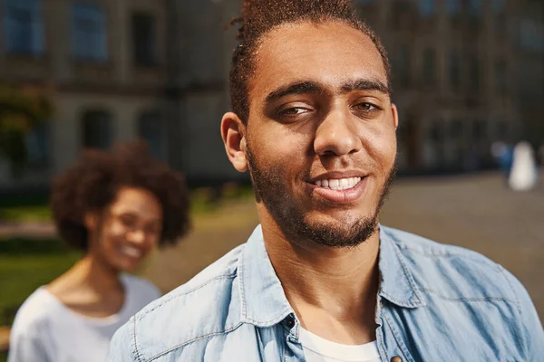 Cheerful people smiling outdoors and looking glad — Photo