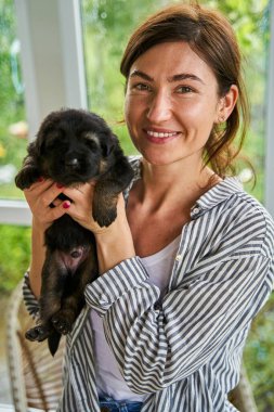 Happy female person spending time with little animal friend