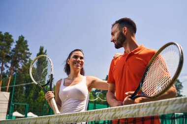 Raketlerle birbirine bakan iki profesyonel genç sporcu.