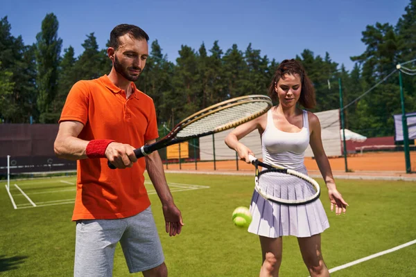 Dois jogadores de tênis atraentes focados em sua sessão de treinamento — Fotografia de Stock