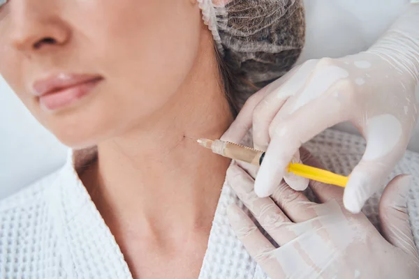 Focused photo on female client doing anti-age injection — Stockfoto