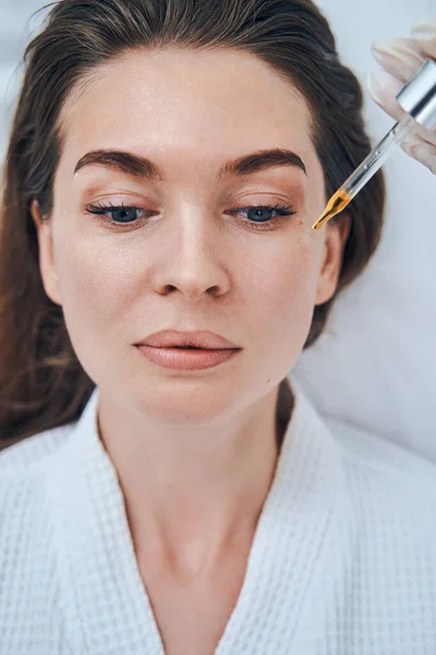 Portrait of cute woman enjoying beauty procedure — Stockfoto