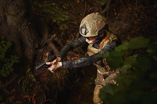 Female person aiming with gun at target — Stock Photo, Image