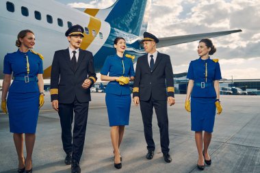 Uçuş görevlileri ve pilotlar birbirleriyle eğleniyorlar.
