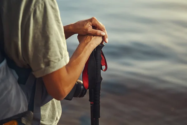 Hand of tourist laying on walking pole handle — Stock Photo, Image