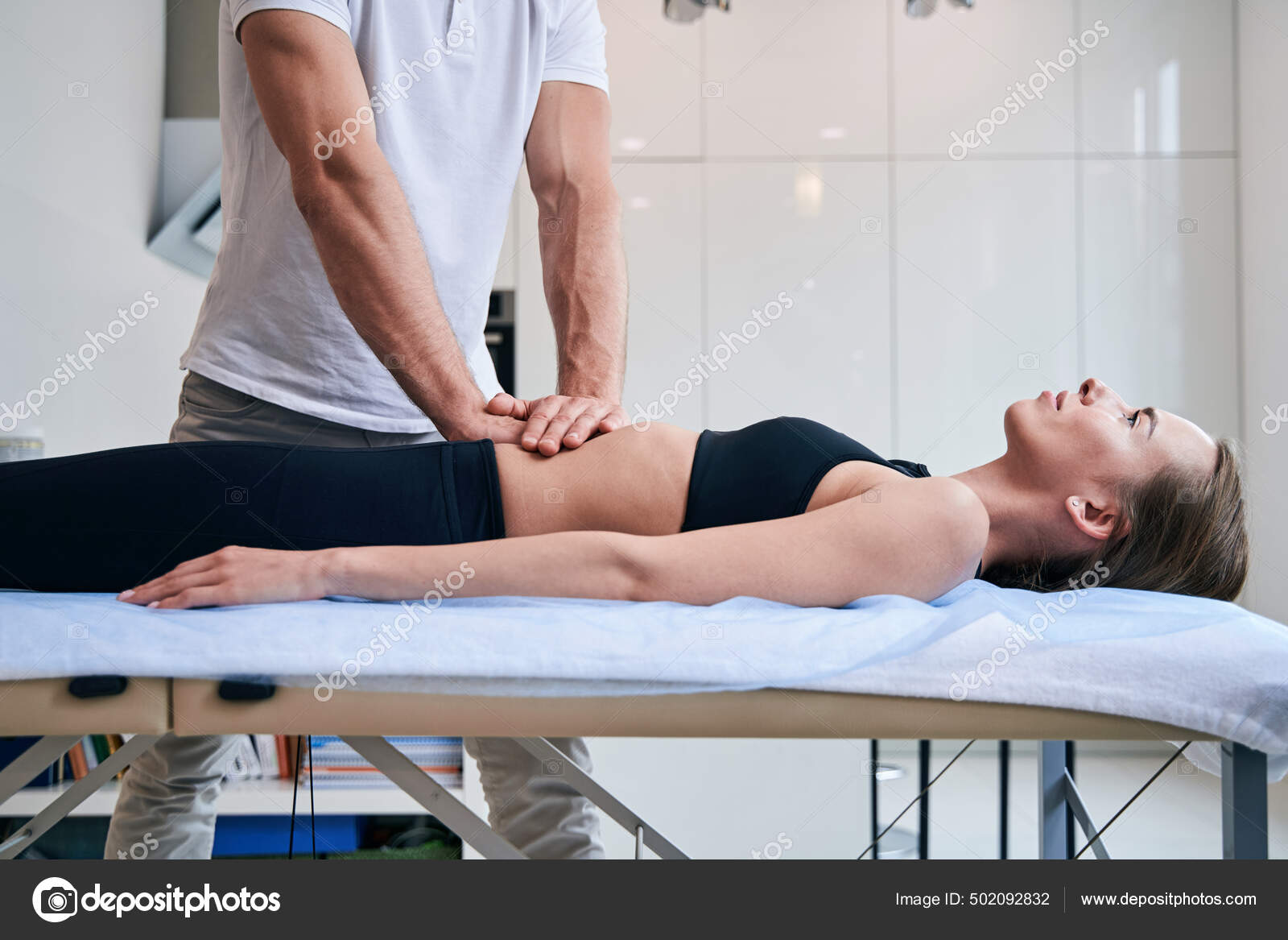Beautiful elegant female on massage table getting massage therapy